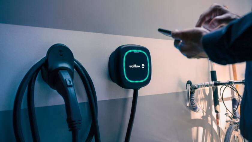 Tecnología clave para cargar autos eléctricos mediante sistema Wallbox instalado en estación de carga moderna.
