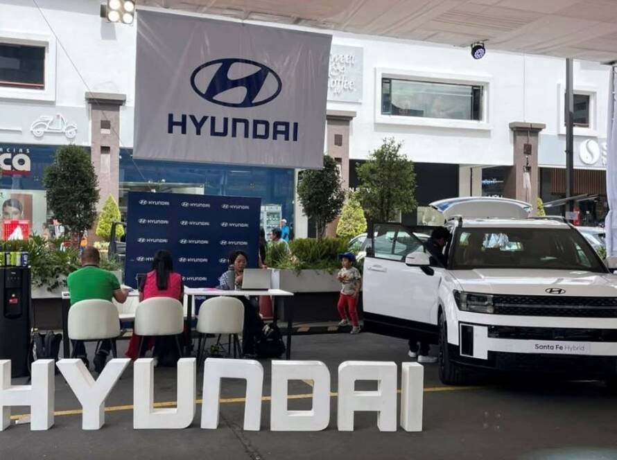 Stand de exhibición del Carfest 2026 con Hyundai mostrando vehículos híbridos y asesores comerciales.