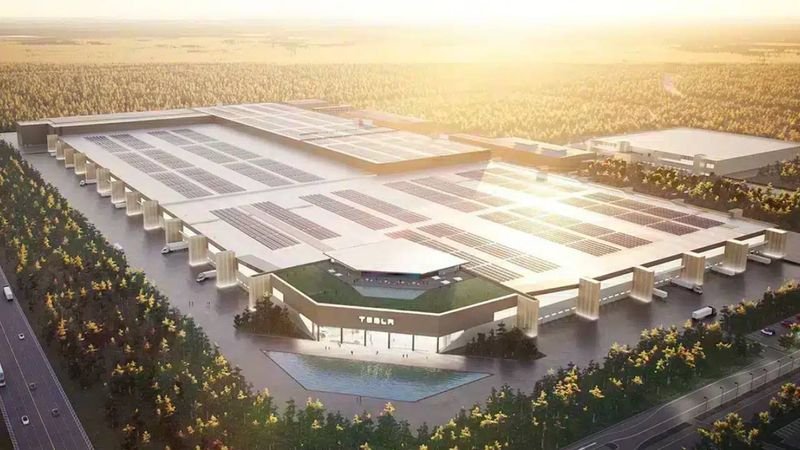 Instalaciones de la fábrica de Tesla en Berlín, con maquinaria y personal trabajando en la producción de vehículos eléctricos