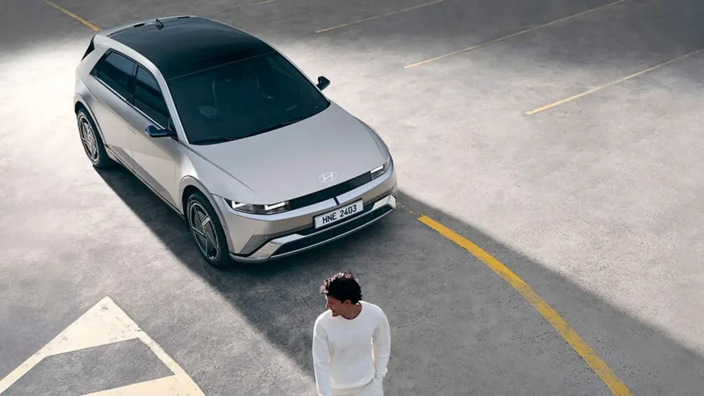 Vista tres cuartos delantera del nuevo Hyundai Ioniq 5 circulando por un entorno urbano.