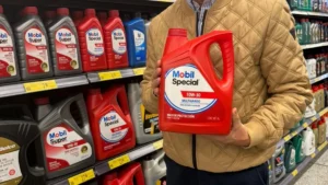 Christian Ayala, director comercial de Terpel Lubricantes Ecuador, sostiene un envase de Mobil Special en un local Megamaxi